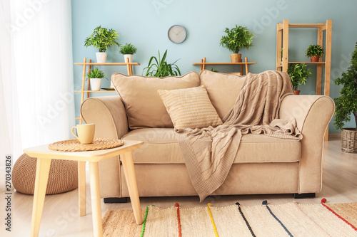 Interior of light modern room with comfortable sofa © Pixel-Shot
