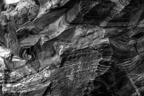 Natural black volcanic stone texture venetian plaster background. Dark volcanic rock venetian plaster stone texture grain pattern. Black grunge charcoal background texture rock
