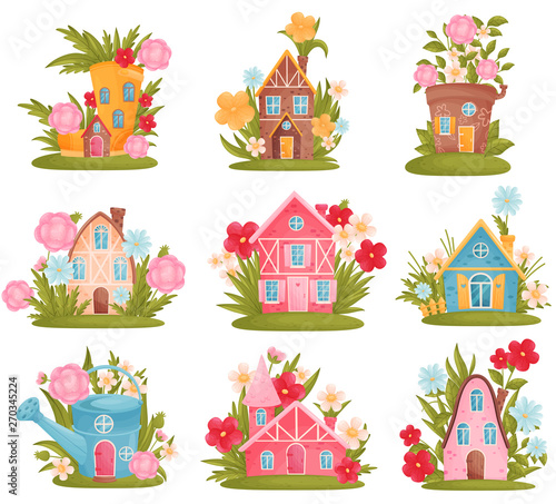 Set of fabulous houses among the flowers and grass. Vector illustration on white background.