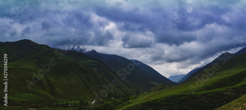 Valley with dramatic dark clouds and rain  storm clouds over the valley  view from the gorge.