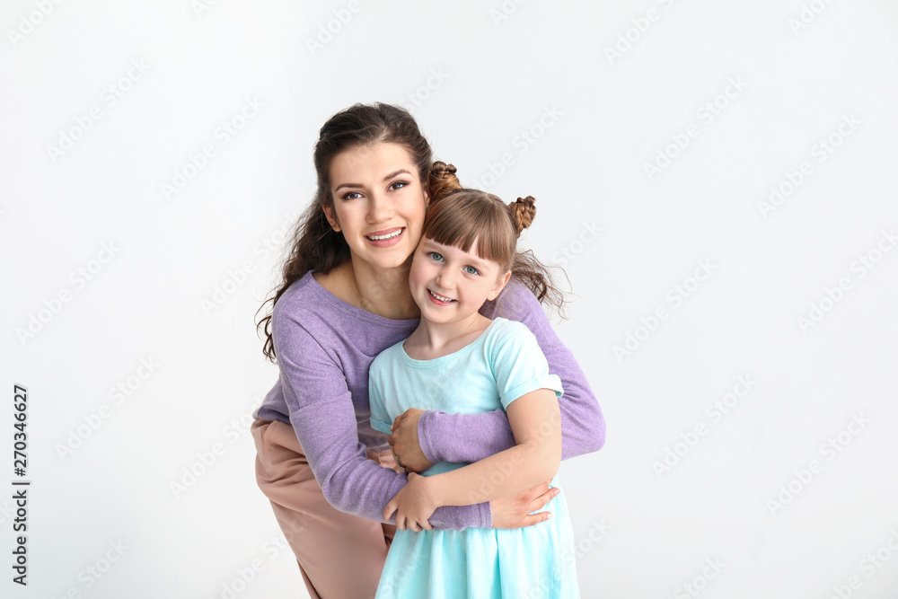 Happy mother with little adopted girl on white background Happy mother with little adopted girl on white background