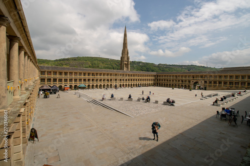 Halifax West Yorkshire UK, 10th May 2019: Photo of the famous Piece Hall in the Blackledge area of Halifax, showing the historic stone build building, taken on a part cloudy sunny day.