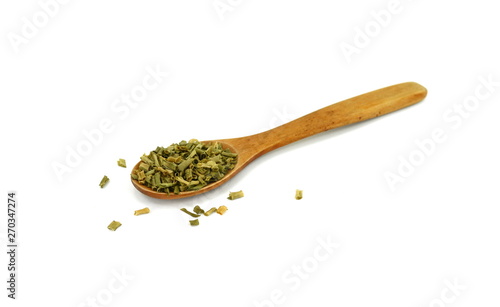 Dried chives chopped in a wooden spoon isolated on white background