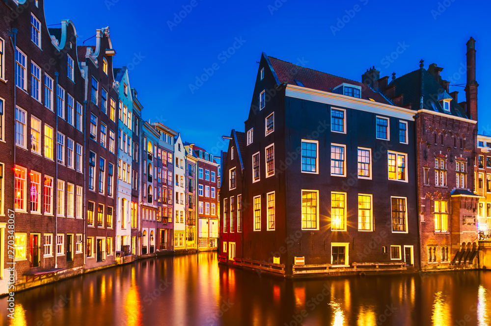 Typical old dutch houses over canal with reflections at twilight in Amsterdam, North Hilland, Netherlands. Amsterdam postcard.