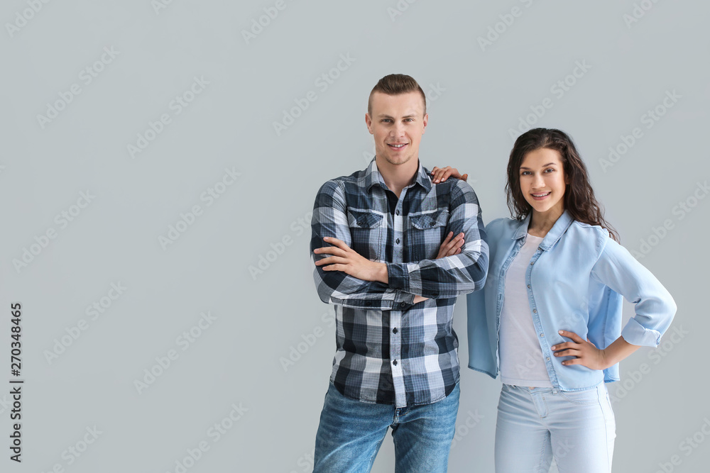 Naklejka premium Adorable loving couple on grey background