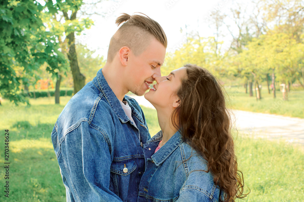 Fototapeta premium Adorable loving couple resting in park
