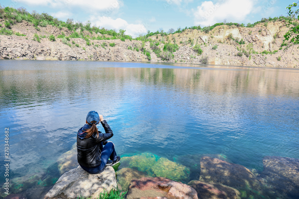 Female tourist near beautiful mountain lake Female tourist near beautiful mountain lake