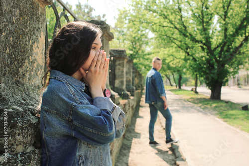 Sad young girlfriend after quarrel with her boyfriend outdoors © Pixel-Shot