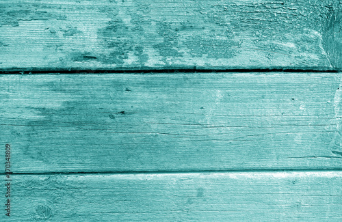 Weathered wooden painted wall in cyan tone.