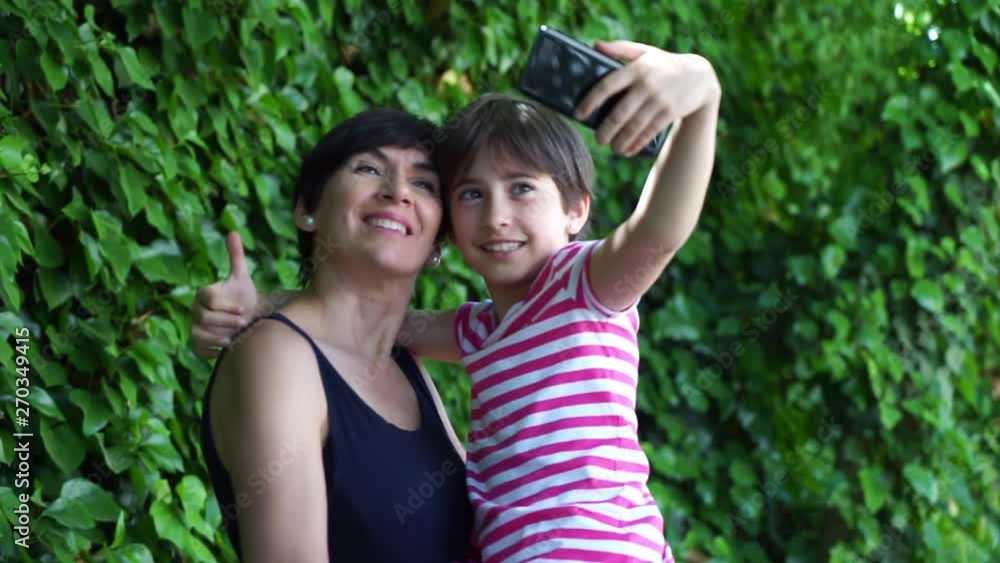 Little daughter and her mother taking selfie photo. Little daughter and her mother taking selfie photo.