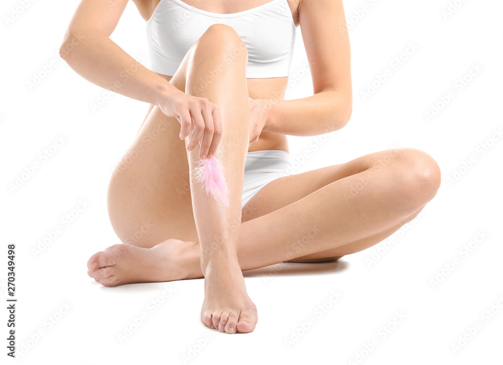 Beautiful young woman with smooth skin after depilation on white background