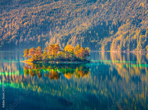 Colorful islang glowing by sunlight on the Eibsee lake. Splendid outdoor scene in German Alps, Bavaria, Garmisch-Partenkirchen village location, Germany, Europe. Beauty of nature concept background. photo