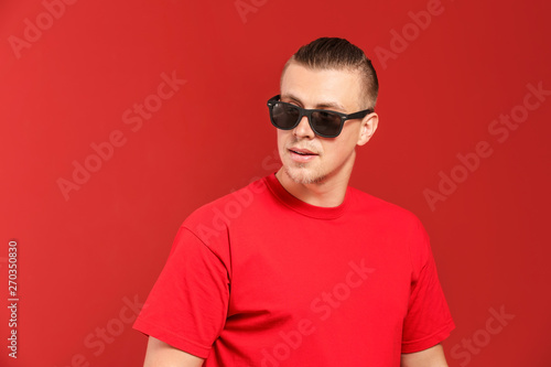 Cool young man on color background