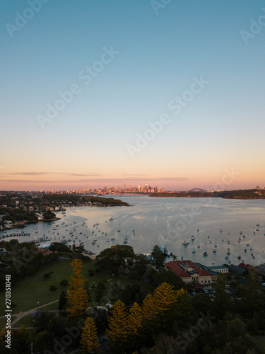 Aerial view of Sydney Harbour under the sunrise light.