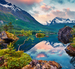 Impressive summer sunrise on the Innerdalsvatna lake. Colorful morning scene in Norway, Europe. Beauty of nature concept background. Artistic style post processed photo.