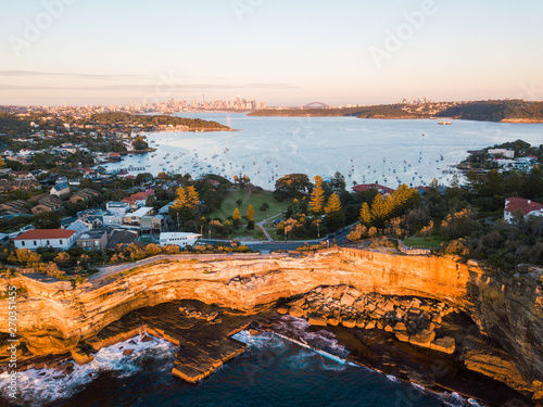 Aerial view of Sydney coastline with CBD skyline on the background.