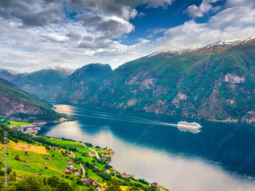 Awesome summer view of Sognefjorden fjord. Colorful morning scene with Aurlandsvangen village, Norway. Traveling concept background. Artistic style post processed photo.
