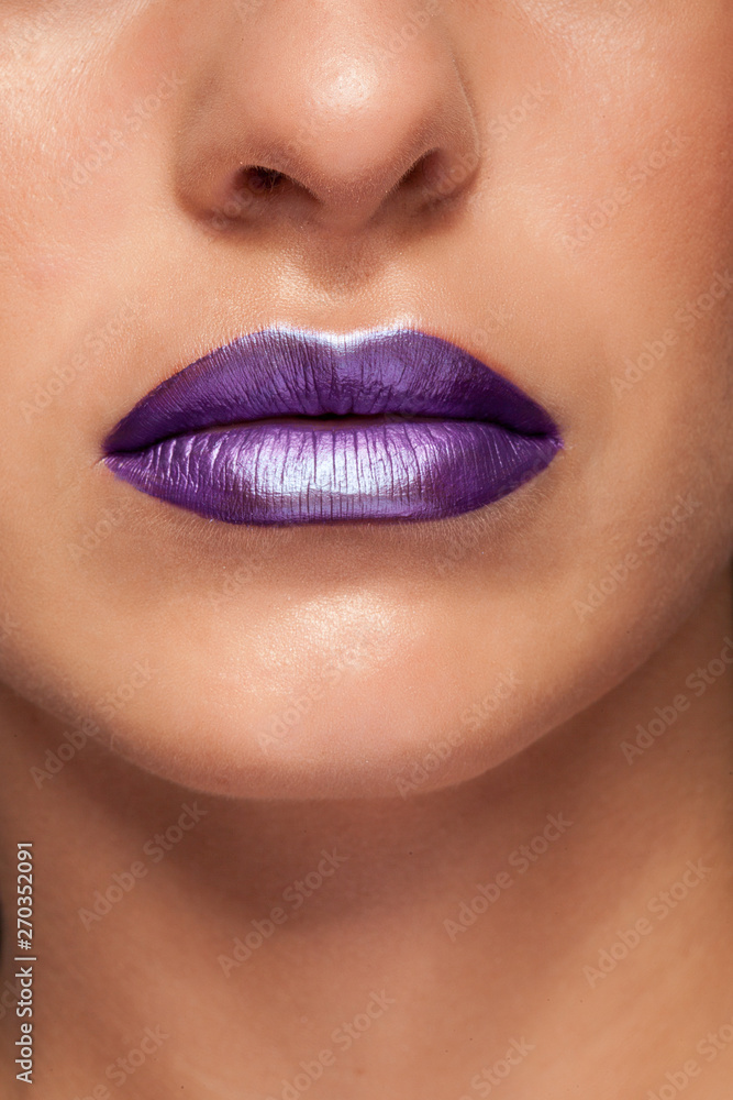 Fototapeta premium Close up view of beautiful woman lips with glossy lipstick.