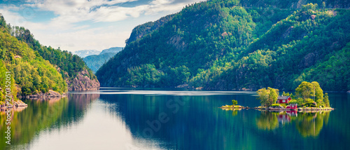 Picturesque summer panorama with small island with typical Norwegian building on Lovrafjorden flord, North sea. Colorful morning view in Norway. Beauty of nature concept background. photo