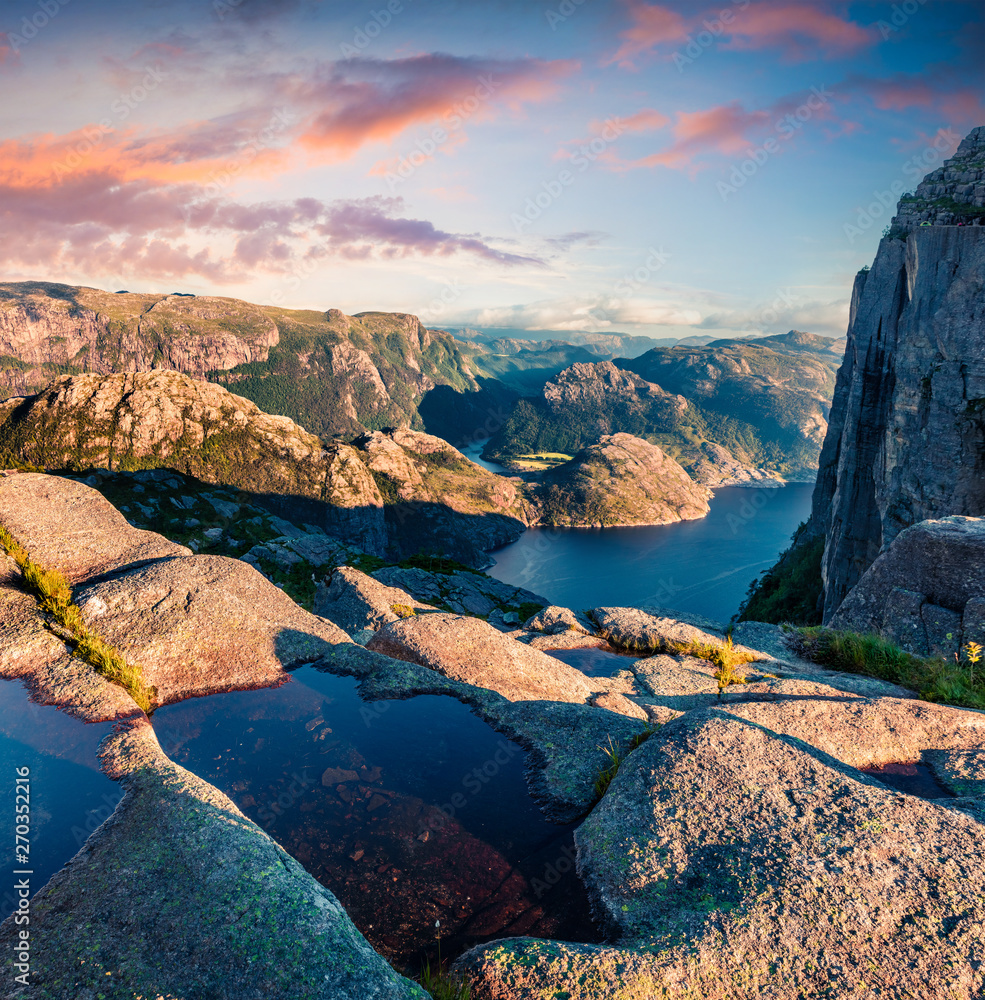 Colorful evening view of popular Norwegian attraction Preikestolen. Great summer scene of the Lysefjorden fjord, located in the Ryfylke area in southwestern Norway.