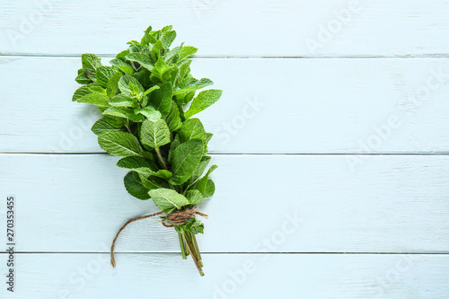 Bunch of fresh mint on white wooden background