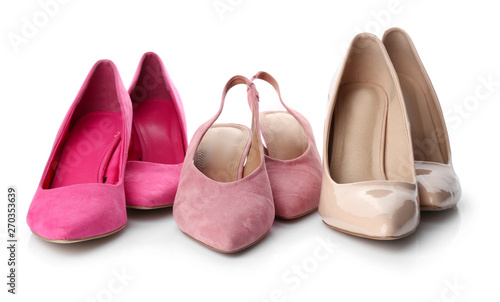 Different stylish female shoes on white background