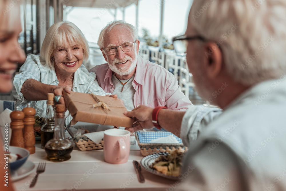 Pleased elderly woman looking at her friend Pleased elderly woman looking at her friend