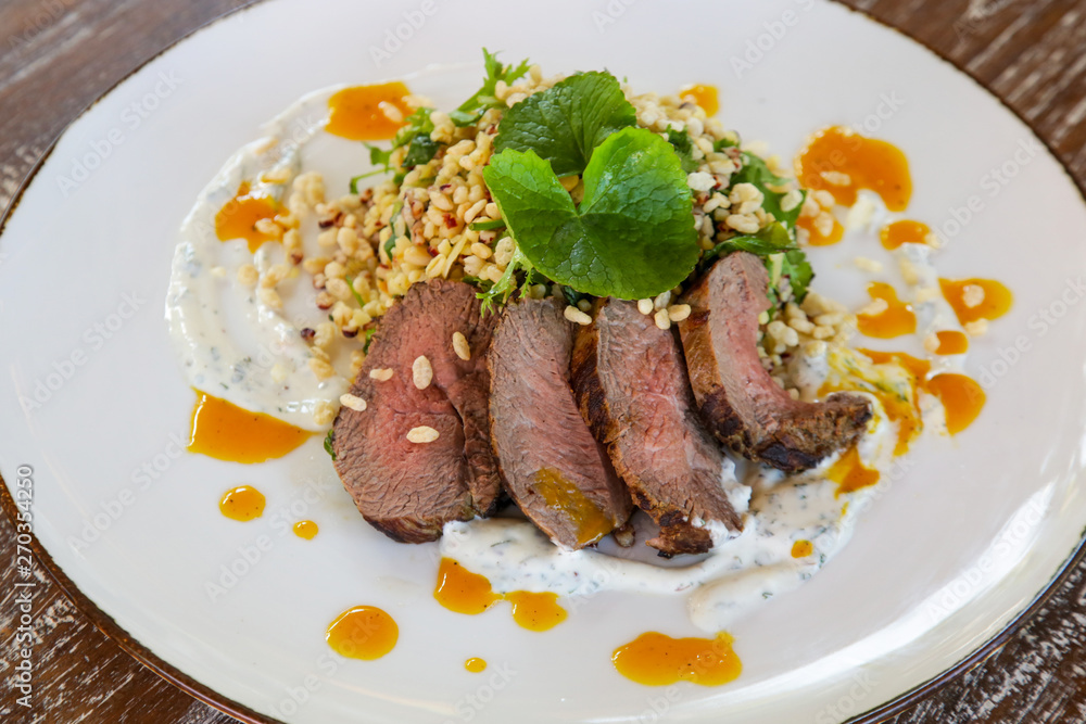 Lamb tenderloin served with barley salad Lamb tenderloin served with barley salad