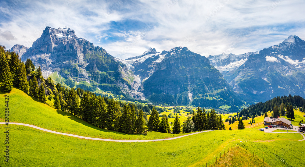 Picturesque morning panorama of Grindelwald village valley from cableway. Wetterhorn and Wellhorn mountains, located west of Innertkirchen in the Bernese Oberland Alps. Switzerland, Europe.