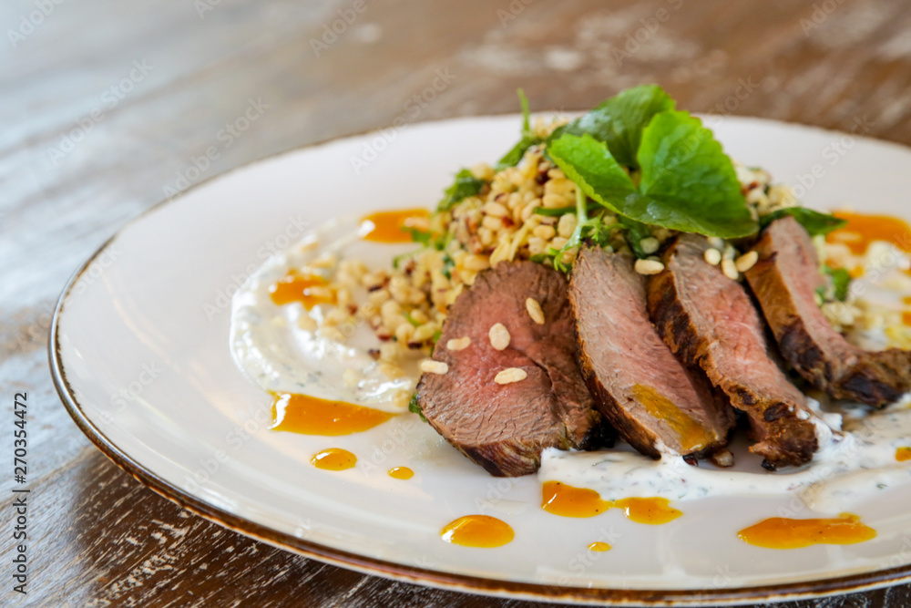 Lamb tenderloin served with barley salad Lamb tenderloin served with barley salad
