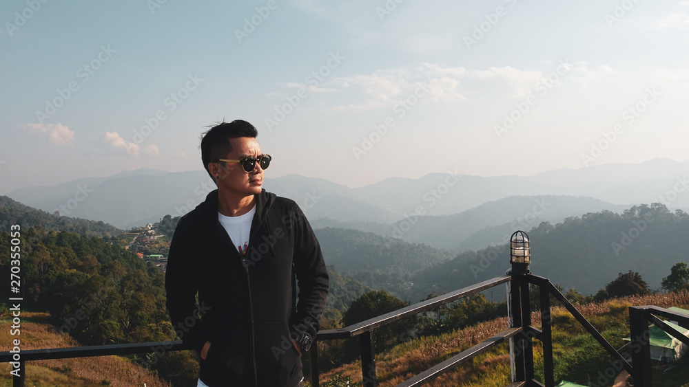 Asian men standing on the terrace at the morning landscape background