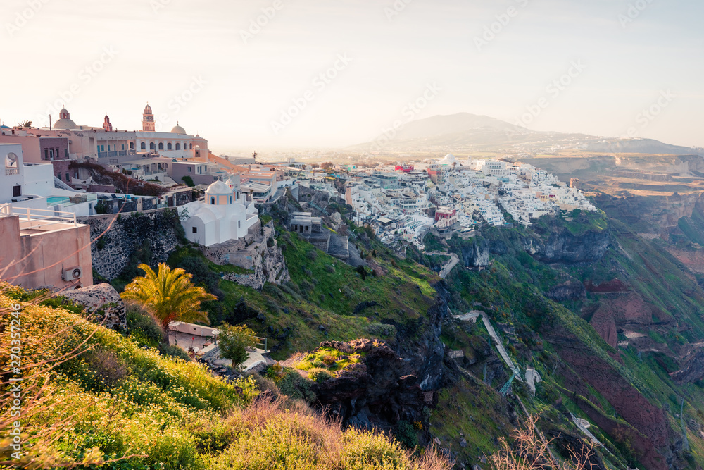 Sunny morning scene of Santorini island. Great spring view of the famous Greek resort Fira, Greece, Europe. Traveling concept background. Artistic style post processed photo.