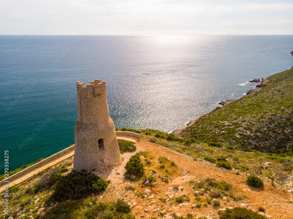 Torre del Gerro tower. Ancient 16th century watchtower on the top of a cliff in Denia, Spain