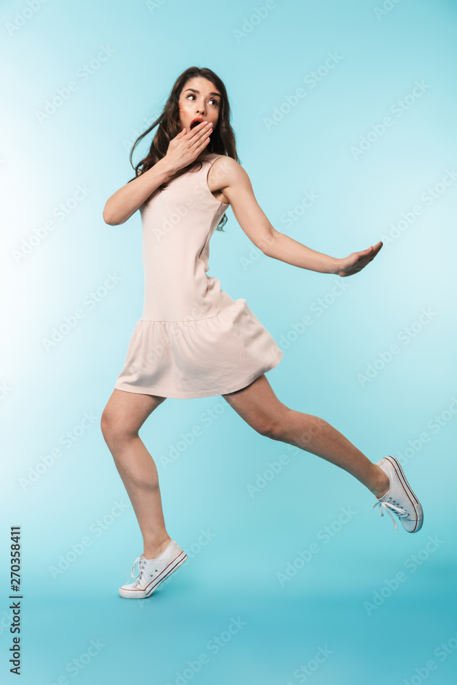 Full length of a cheerful young brunette woman standing Full length of a cheerful young brunette woman standing