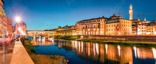 Great evening cityscape of Florence with Old Palace (Palazzo Vecchio or Palazzo della Signoria) on background and Ponte Vecchio bridge over Arno river. Colorful night panorama of Italy, Europe.