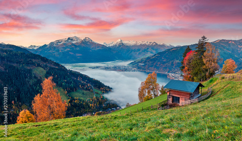 Fantastic morning scene of Zell lake. Great autumn sunrise view of Austrian town - Zell am See, south of the city of Salzburg. Beauty of nature concept background. photo
