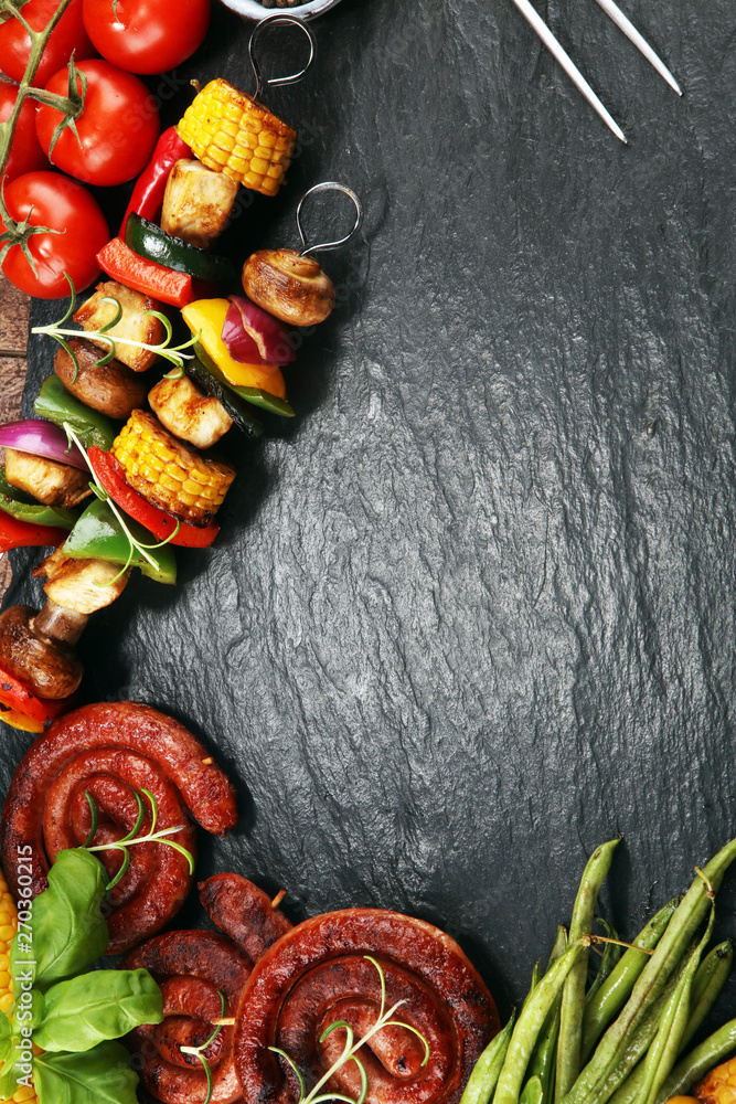 Assorted delicious grilled meat and skewer with vegetable on rustic table
