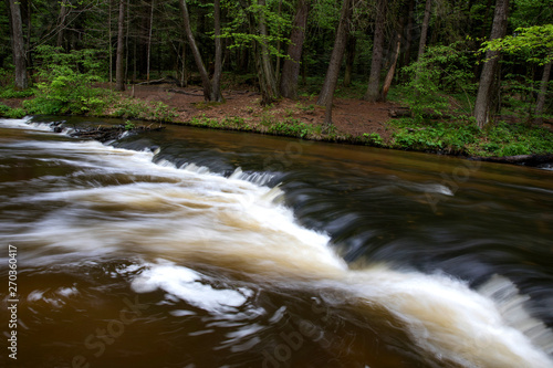 Mountain stream, River deep in mountain forest, Mountain creek cascade with fresh green moss on the stones