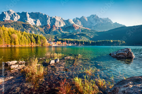 Marvelous evening scene of Eibsee lake with Zugspitze mountain range on background. Exciting autumn view of Bavarian Alps, Germany, Europe. Beauty of nature concept background. photo
