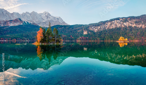 Spectacular morning scene of Eibsee lake with Zugspitze mountain range on background. Colorful autumn view of Bavarian Alps, Germany, Europe. Beauty of nature concept background.