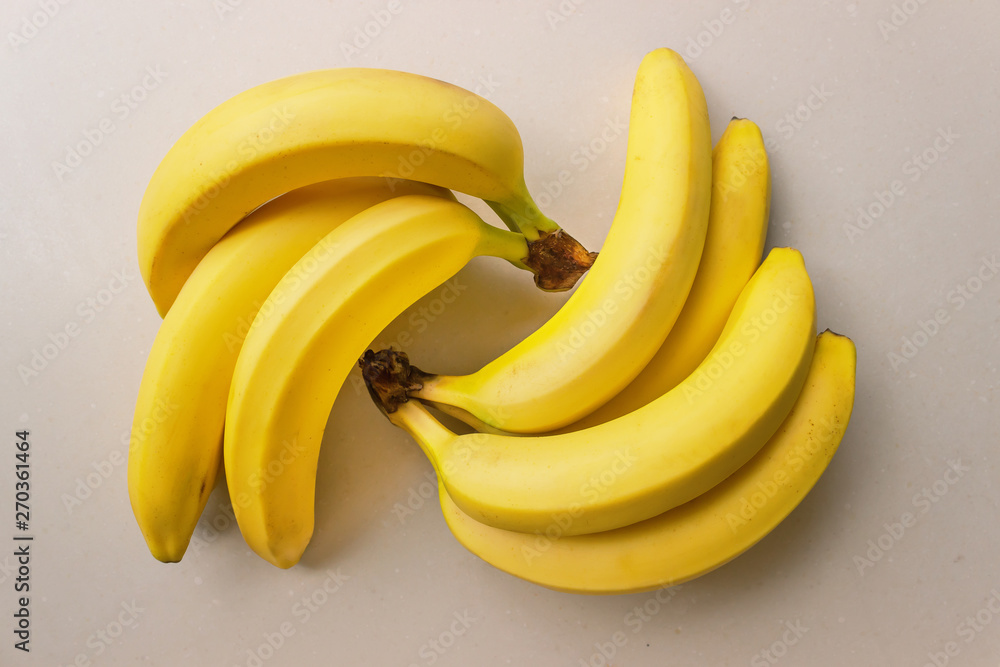 Bunch of ripe bananas on a light background. Concept- organic fruit, healthy food. Bunch of ripe bananas on a light background. Concept- organic fruit, healthy food.