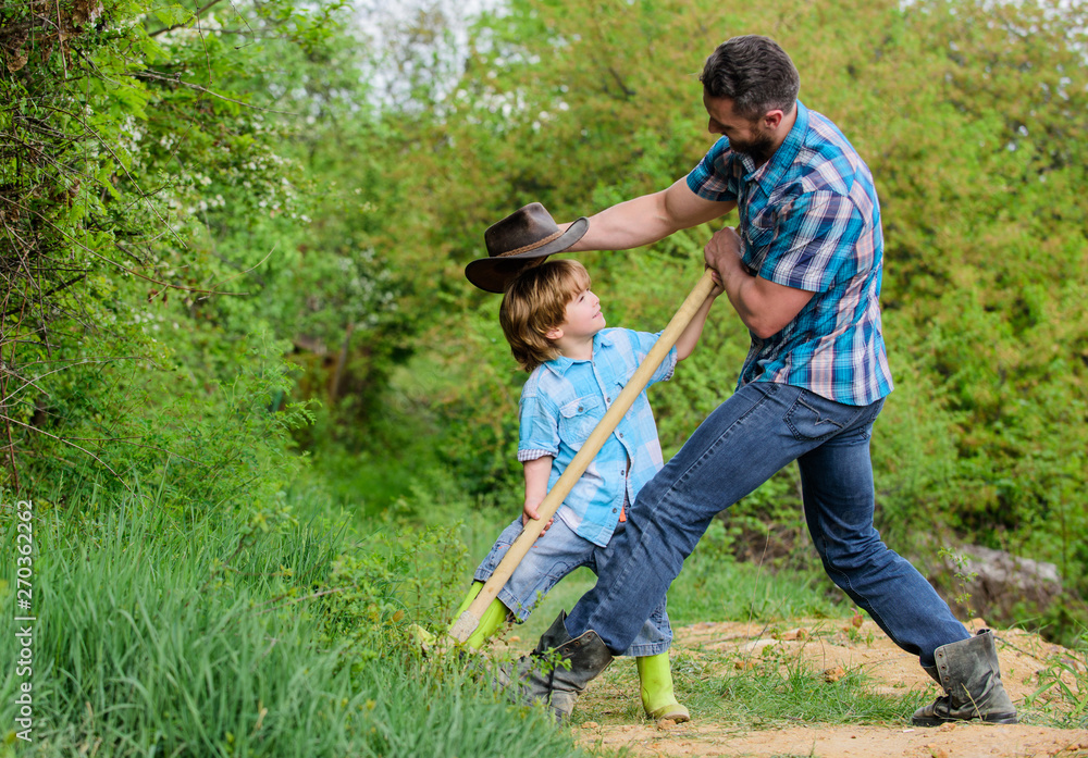 Cute child in nature having fun cowboy dad. Find treasures. Little boy and father with shovel looking for treasures. Spirit of adventures. Adventure hunting for treasures. Little helper in garden Cute child in nature having fun cowboy dad. Find treasures. Little boy and father with shovel looking for treasures. Spirit of adventures. Adventure hunting for treasures. Little helper in garden