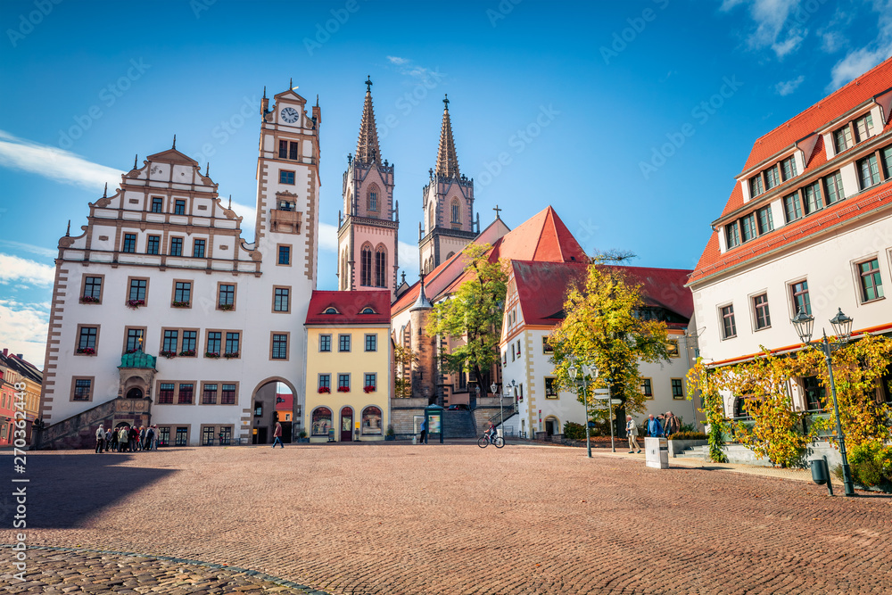 Splendid autumn view of Oschatz central square with Stadtverwaltung and St. Aegidien church. Colorful morning scene of Saxony, Germany, Europe. Traveling concept background.