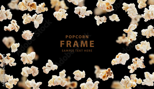 Popcorn frame, flying popcorn isolated on black background with copy space, movie poster concept photo