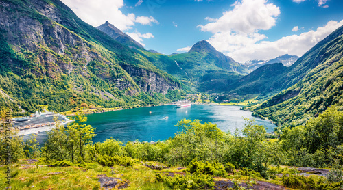 Splendid summer scene of Geiranger port  western Norway. Aerial morning view of Sunnylvsfjorden fjord. Traveling concept background. Artistic style post processed photo.