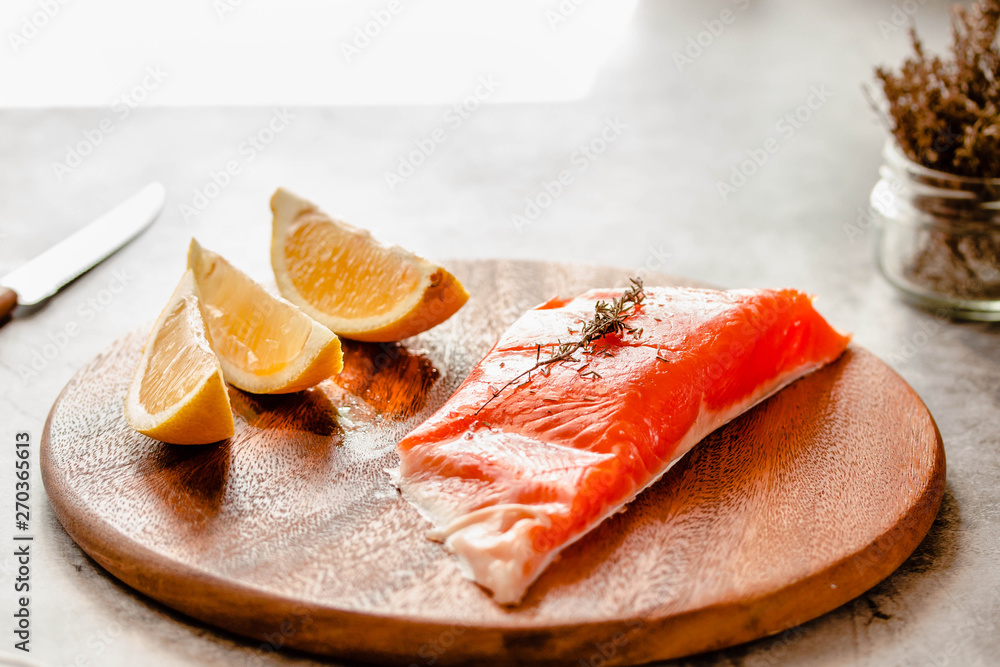 Raw salmon fish filet with lemon and spices. On a wooden background. Raw salmon fish filet with lemon and spices. On a wooden background.