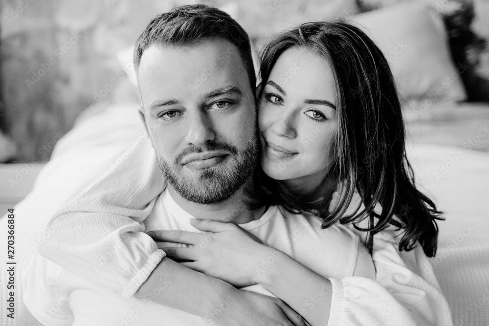 Couple in love in the bedroom. Slender brunette. Stylish interior. Couple in love in the bedroom. Slender brunette. Stylish interior.