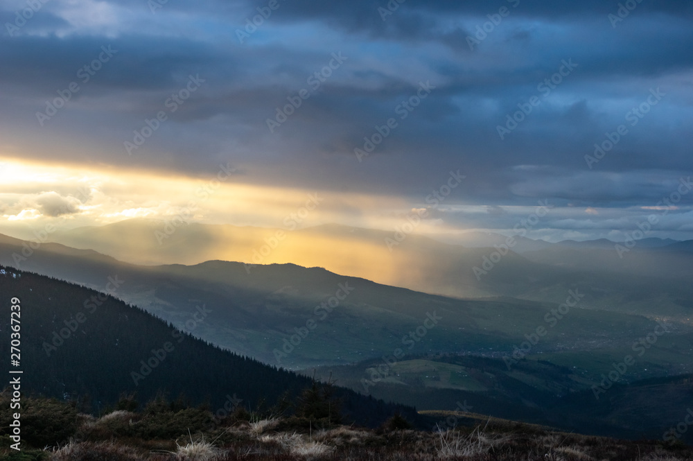 Rays of the sun at sunset in the mountains