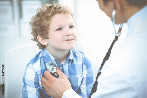 Doctor and patient child. Physician examining little boy. Regular medical visit in clinic. Medicine and health care concept