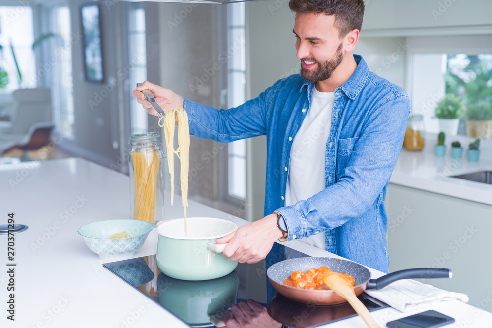 Handsome man cooking pasta at home Handsome man cooking pasta at home